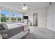Cozy bedroom features a ceiling fan, TV, and large windows offering scenic views at 14350 Ludwell Ct, Fishers, IN 46037