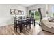 Inviting dining area featuring a table with seating for six, slider doors to outside, next to living area at 14350 Ludwell Ct, Fishers, IN 46037