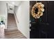 A beautifully adorned front door and staircase complement the wooden floors in this welcoming foyer at 14350 Ludwell Ct, Fishers, IN 46037