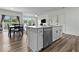 Open concept kitchen with stainless steel appliances, an island, and a view into the dining and living spaces at 14350 Ludwell Ct, Fishers, IN 46037