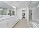 Modern bathroom with dual sinks, white cabinets, tiled floors, and a glass enclosed shower at 1510 Stonehaven Dr, Westfield, IN 46074