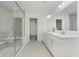 Modern bathroom with dual sinks, white cabinets, and a tiled shower behind glass at 1510 Stonehaven Dr, Westfield, IN 46074