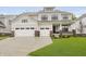 Beautiful two-story home featuring a three-car garage, professional landscaping, and neutral-colored siding at 1510 Stonehaven Dr, Westfield, IN 46074