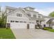 Charming two-story home featuring a three-car garage, professional landscaping, and neutral-colored siding at 1510 Stonehaven Dr, Westfield, IN 46074
