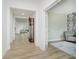 Hallway view showcasing the stylish wood floors, white walls, and doors leading to other rooms at 1510 Stonehaven Dr, Westfield, IN 46074