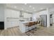 Stylish kitchen with white cabinetry, stainless steel appliances, a center island, and modern lighting fixtures at 1510 Stonehaven Dr, Westfield, IN 46074