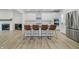 Open-concept kitchen with white cabinets, stainless steel appliances, and a large island with bar seating at 1510 Stonehaven Dr, Westfield, IN 46074