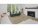 Cozy living room featuring large windows, comfortable seating, and a modern fireplace at 1510 Stonehaven Dr, Westfield, IN 46074