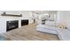 Open-concept living room with fireplace, modern kitchen, and cozy sectional sofa at 1510 Stonehaven Dr, Westfield, IN 46074