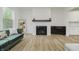 Open-concept living room with modern furnishings, a fireplace, and views into the kitchen at 1510 Stonehaven Dr, Westfield, IN 46074