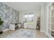 Stylish office with patterned wall, desk, chair, and natural light streaming through the bright window at 1510 Stonehaven Dr, Westfield, IN 46074