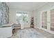 Comfortable office featuring light-colored wood floors, a patterned accent wall, desk, chair, and natural light at 1510 Stonehaven Dr, Westfield, IN 46074