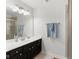 Well-lit bathroom featuring a dark vanity, white countertop, and a large mirror at 15292 Slateford Rd, Noblesville, IN 46062