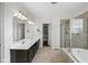 Bathroom features dual sinks, a soaking tub, and a glass-enclosed shower at 15292 Slateford Rd, Noblesville, IN 46062