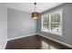 Neutral bedroom with dark hardwood floors, modern light fixture, and large window at 15292 Slateford Rd, Noblesville, IN 46062