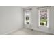 Bright bedroom with neutral carpet and two windows, offering a view of the neighborhood at 15292 Slateford Rd, Noblesville, IN 46062