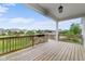 Spacious wood deck features a serene outdoor view and hanging light fixture at 15292 Slateford Rd, Noblesville, IN 46062