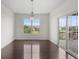 Bright dining room with hardwood floors, a large window, and sliding glass doors to the deck at 15292 Slateford Rd, Noblesville, IN 46062