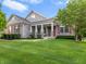 Charming stone home with red shutters and a well-manicured lawn on a sunny day at 15292 Slateford Rd, Noblesville, IN 46062
