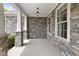 Covered front porch with stone pillars and exterior stone wall at 15292 Slateford Rd, Noblesville, IN 46062