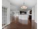 Open-concept kitchen features an island, hardwood floors, stainless appliances, and pendant lighting at 15292 Slateford Rd, Noblesville, IN 46062
