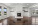 Bright living room with hardwood floors, fireplace, and custom shelving at 15292 Slateford Rd, Noblesville, IN 46062