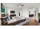 Spacious main bedroom with hardwood floors, a ceiling fan, and a view of the ensuite bathroom at 15292 Slateford Rd, Noblesville, IN 46062