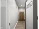 Hallway featuring an open door to the wine cellar and a wooden wine rack at 15292 Slateford Rd, Noblesville, IN 46062