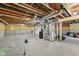 Unfinished basement featuring concrete floor, exposed rafters, and mechanicals at 15418 Tattersalls Ln, Fishers, IN 46040