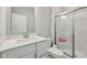 Bright bathroom with white vanity, quartz countertop, and glass-enclosed shower at 15418 Tattersalls Ln, Fishers, IN 46040
