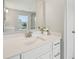 Bathroom vanity with white cabinets, white countertop, chrome faucet, and large mirror at 15418 Tattersalls Ln, Fishers, IN 46040