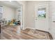 Bright entryway featuring wood floors, a glass paneled front door, and adjacent playroom at 15418 Tattersalls Ln, Fishers, IN 46040
