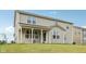 Exterior of home with covered back porch and large double hung windows at 15418 Tattersalls Ln, Fishers, IN 46040
