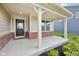 Cozy covered front porch with brick accents and ample space for seating at 15418 Tattersalls Ln, Fishers, IN 46040