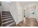 Inviting hallway with staircase, wood floors, and easy access to main living areas at 15418 Tattersalls Ln, Fishers, IN 46040