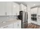 Modern kitchen featuring stainless steel appliances, white cabinets, and beautiful quartz countertops at 15418 Tattersalls Ln, Fishers, IN 46040
