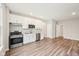 Well-equipped kitchen with stainless steel appliances, white cabinets, and hardwood floors at 15418 Tattersalls Ln, Fishers, IN 46040