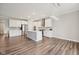 Modern kitchen featuring white cabinets, stainless steel appliances, an island, and an elegant chandelier at 15418 Tattersalls Ln, Fishers, IN 46040