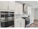 Elegant kitchen with stainless steel appliances, double ovens, and sleek countertops for a modern look at 15418 Tattersalls Ln, Fishers, IN 46040