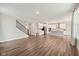 Open-concept living area showcases hardwood floors, staircase, and seamless flow into the modern kitchen at 15418 Tattersalls Ln, Fishers, IN 46040