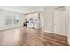 Open-concept living room with hardwood floors, stainless steel appliances, and lots of natural light at 15418 Tattersalls Ln, Fishers, IN 46040