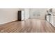 Spacious living room with hardwood floors, plenty of natural light, and a stainless steel refrigerator at 15418 Tattersalls Ln, Fishers, IN 46040