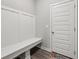 Mudroom with white bench, coat hooks and a door to the garage or exterior at 15418 Tattersalls Ln, Fishers, IN 46040