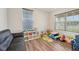 Cozy playroom with natural light, wood floors and space for creative activities at 15418 Tattersalls Ln, Fishers, IN 46040