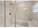 Shower with tile walls, seat, chrome shower head, and glass door at 15418 Tattersalls Ln, Fishers, IN 46040