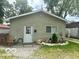 Charming home exterior with green siding, flower bed, and front door at 162 N Gladstone Ave, Columbus, IN 47201