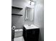 Compact bathroom featuring a modern vanity, floating shelves, and well-lit mirror at 179 E Pearl St, Greenwood, IN 46143