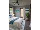 Light bedroom featuring refinished floors, fresh paint, a ceiling fan, and ocean art at 179 E Pearl St, Greenwood, IN 46143