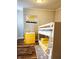Charming ' bedroom features a yellow dresser and white bunk beds with wood-look vinyl flooring at 179 E Pearl St, Greenwood, IN 46143