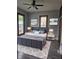 Comfortable bedroom features luxury vinyl plank flooring, updated paint, ceiling fan, and modern decor at 179 E Pearl St, Greenwood, IN 46143